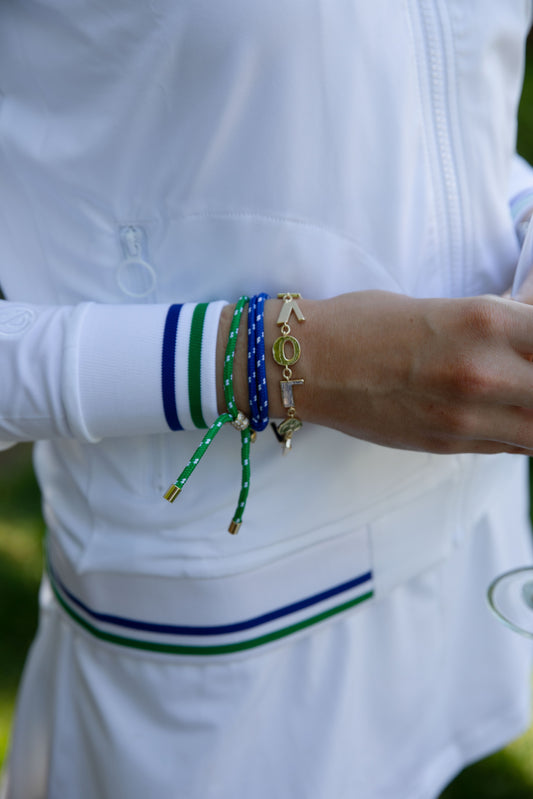 Club & Court Sporty Bracelet Stack worn with tennis whites