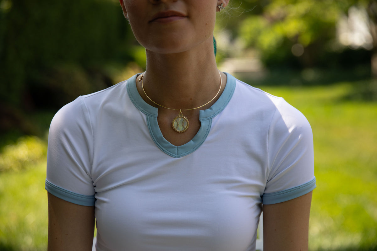 Close-up of the Club & Court Stacy Tee neckline trim
